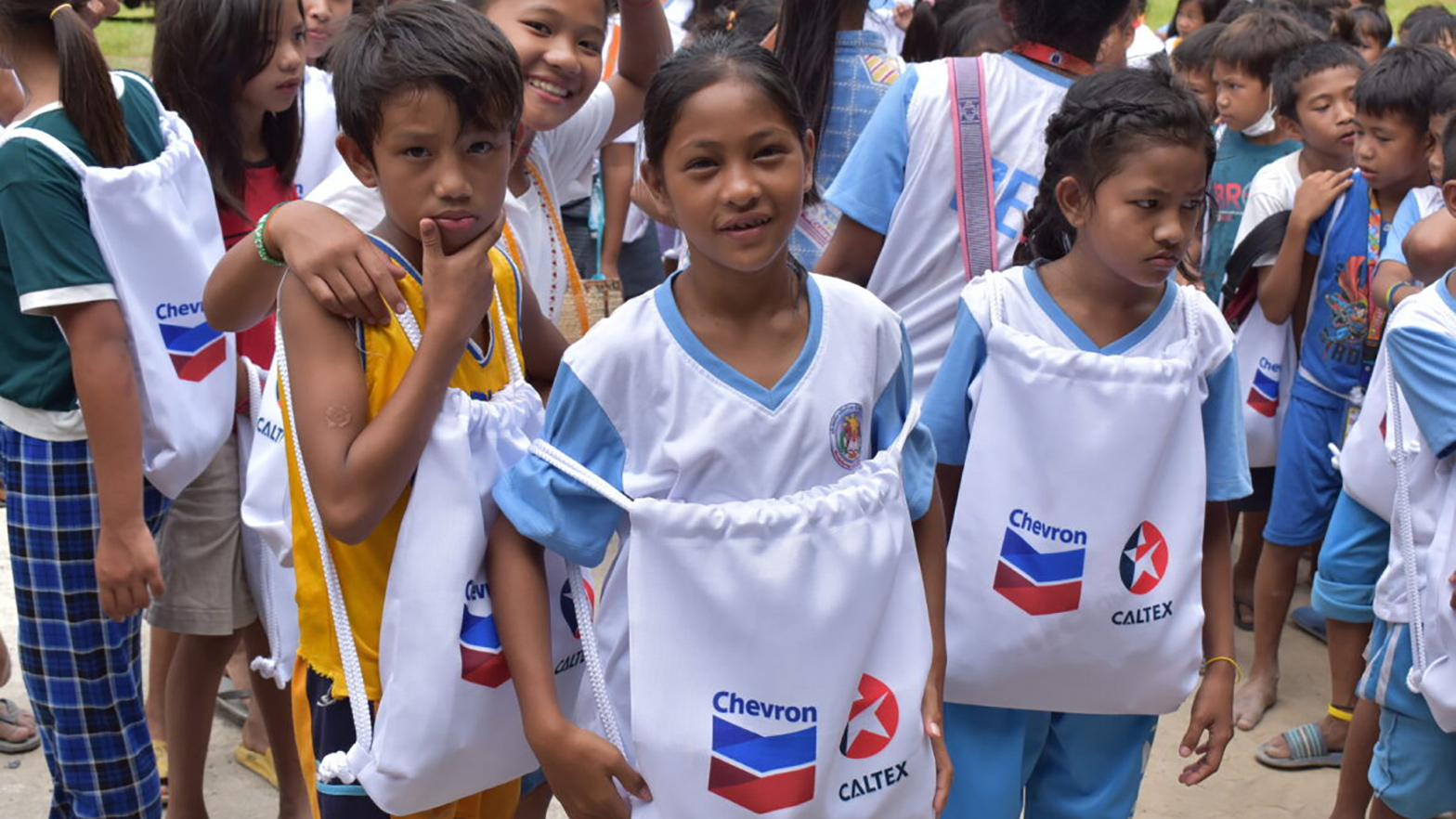 Filipino students holding Chevron bags.