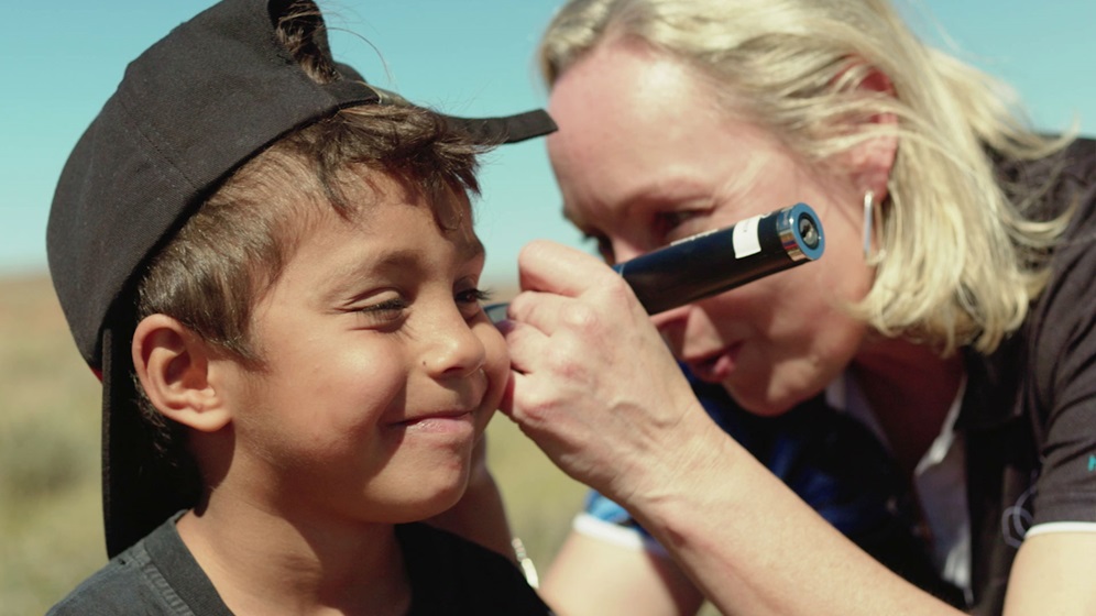 Chevron sponsored Teach, Speech, Hear (TSH) doctor with young boy in Australia